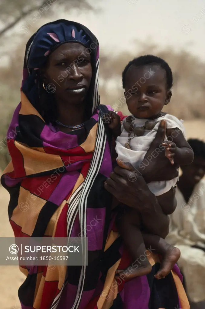 Sudan, North Kordofan Prov., Tribal People, Portrait Of Dar Hamid Woman Carrying Child.  The Dar Hamid Are Nomadic Arab Herders.