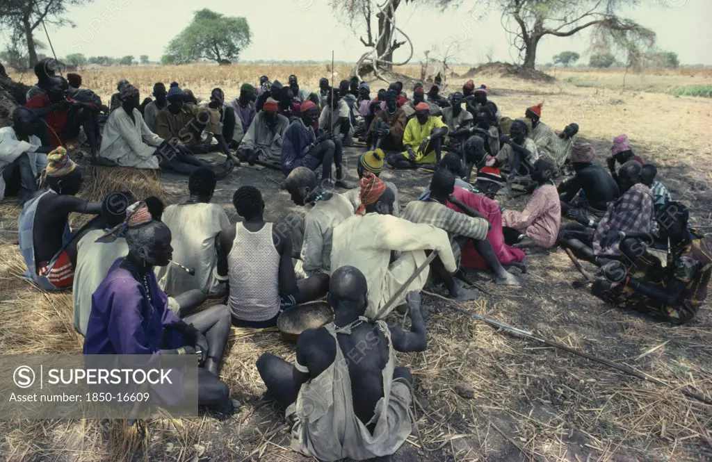 Sudan, Tribal People, Guests At Dinka Wedding Listening To Traditional Story Teller.