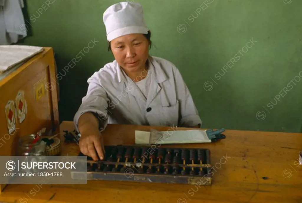 China, Xinjiang, Turfan, Woman Using Abacus