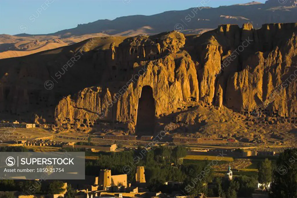 Afghanistan, Bamiyan Province, Bamiyan, View Of Bamiyan Valley And Village Showing Cliffs With Empty Niche Where The Famous Carved Budda Once Stood (Destroyed By The Taliban In 2001)