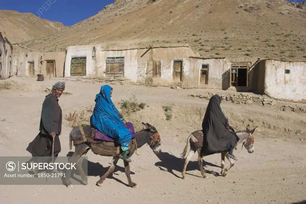 Afghanistan, Between Yakawlang And Daulitiar, Syadara, Man Walking Behind Women On Donkeys