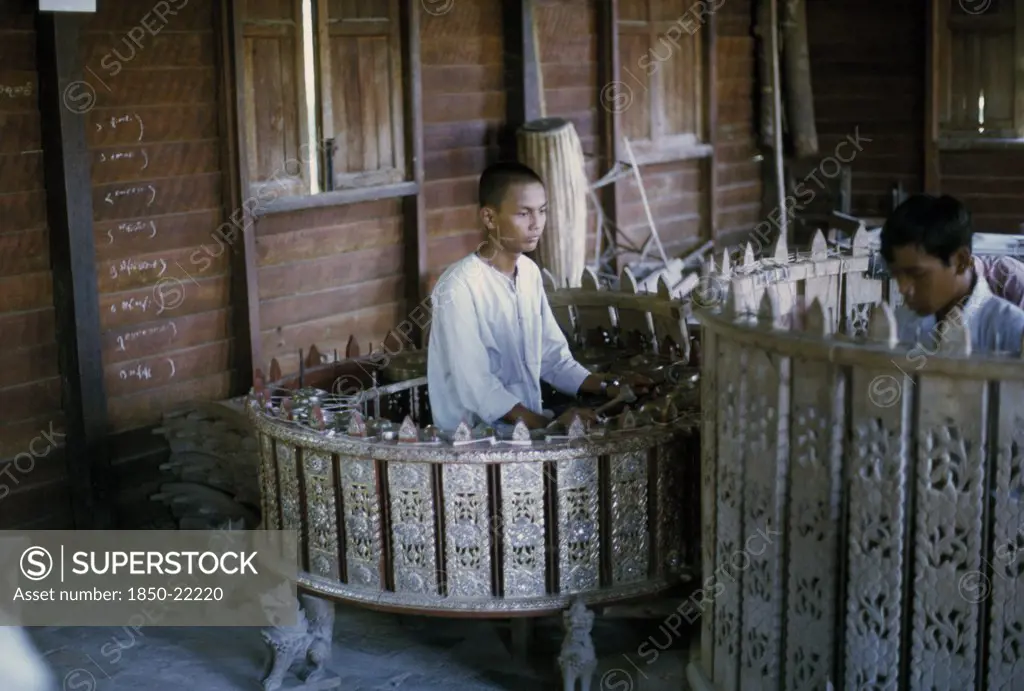 Myanmar, Mandalay, Musician Playing Pat Waing Drum Circle.