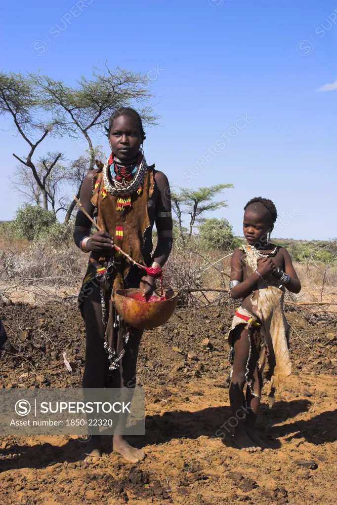 Ethiopia, Lower Omo Valley, Tumi, 'Dombo Village, Child Watching Hamer Lady Stirring Cows Bood Ready For Drinking'