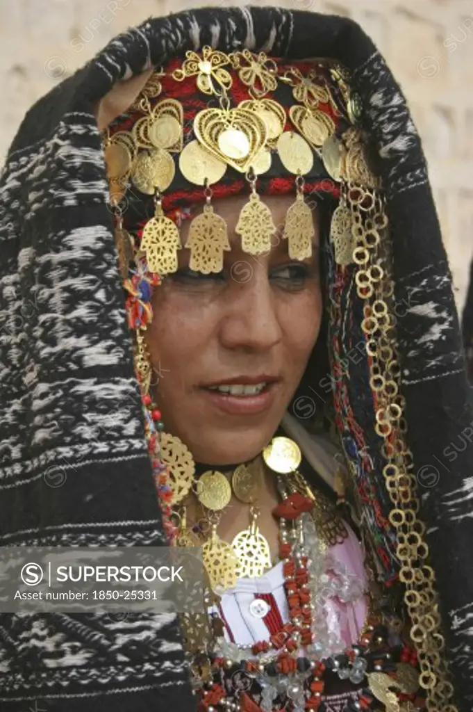 Tunisia, Sahara, Tozeur, 'Head And Shoulders Portrait Of Tunisian Bride Wearing Traditional Dress, Gold Jewelry And Decorated Head Dress In Preparation For Her Wedding Held On The Edge Of The Sahara Desert.'