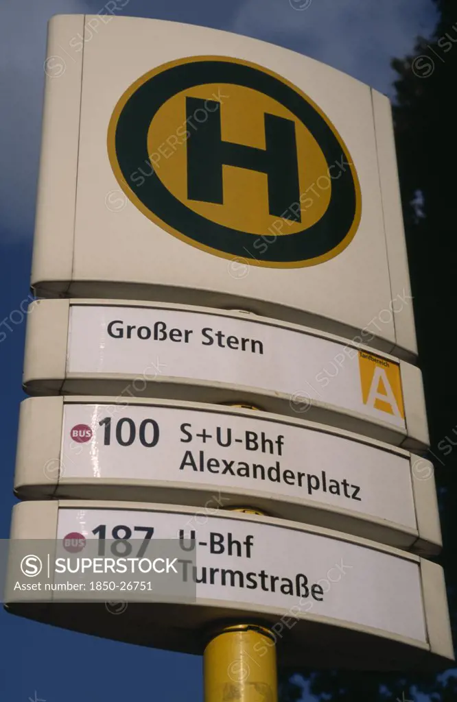 Germany, Berlin, Bus And Tram Stop Sign  Green H Within Yellow Circle Stands For Haltestelle Or Stopping Point.