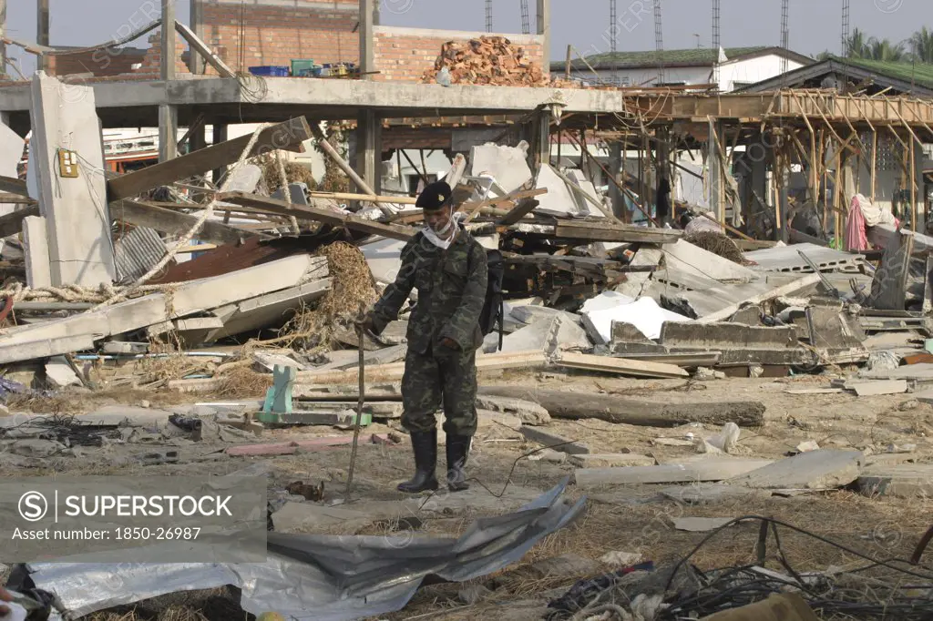 Thailand, Phang Nga District, Nam Khem, 'Tsunami. Thai Army Soldiers Who Has Been Helping In The Clean Up At The Devestated Village Caused By The Tsunami Also Look For Any Bodies, Nothing Is Left Standing In The Village. 2500 People Are Pressumed Dead. 125Kms North Of Phuket On The 2Nd Jan.'