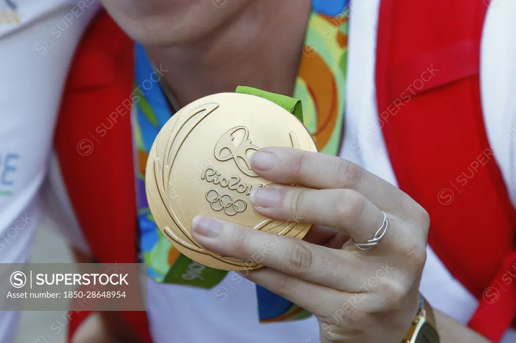 Sport, Olympics, Athlete holding gold medal from Rio games 2016.