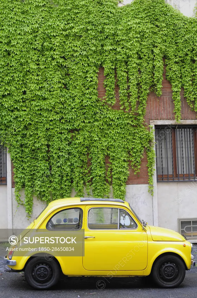 Italy, Lazio, Rome, yellow Fiat 500 'Bambini'.