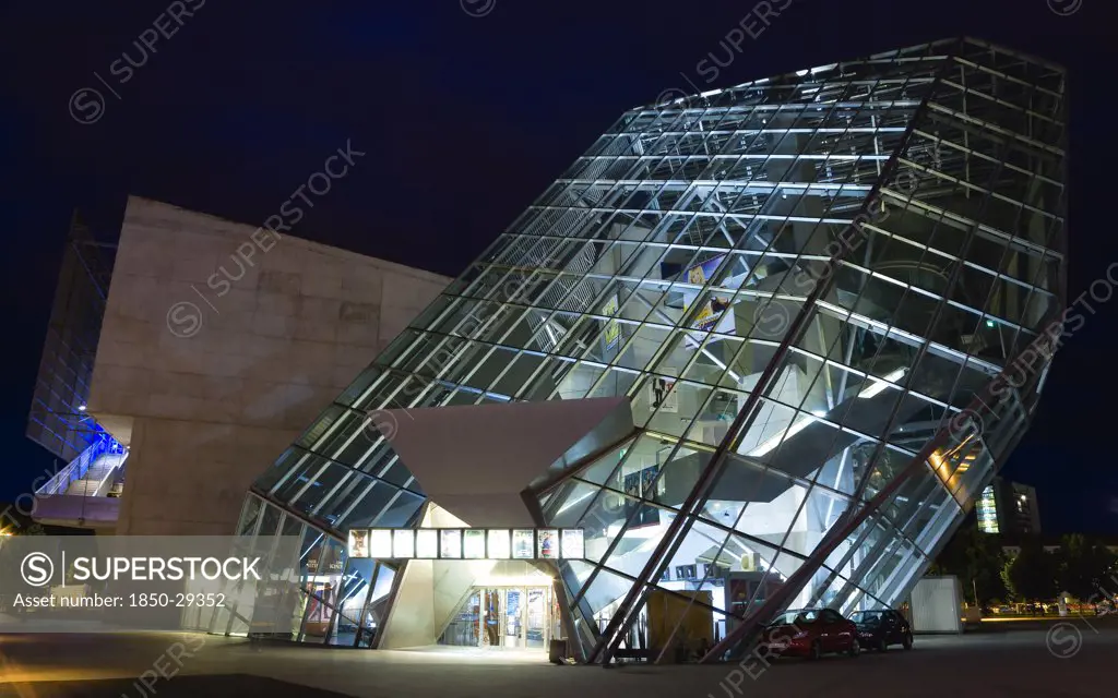 Germany, Saxony, Dresden, The Angular Structure In Glass And Steel Of The 1999 Ufa Palast Cinema Designed By Austrian Architecture Firm Coop Himmelblau Illuminated At Night.