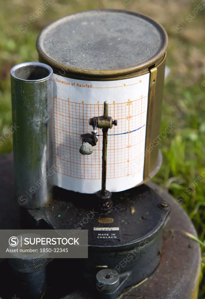 Climate, Weather, Measurements, Tipping Bucket Rain Gauge Recorder with ink pen marking duration of rainfall on graph paper attached to the drum at the Bognor Regis Weather Station.