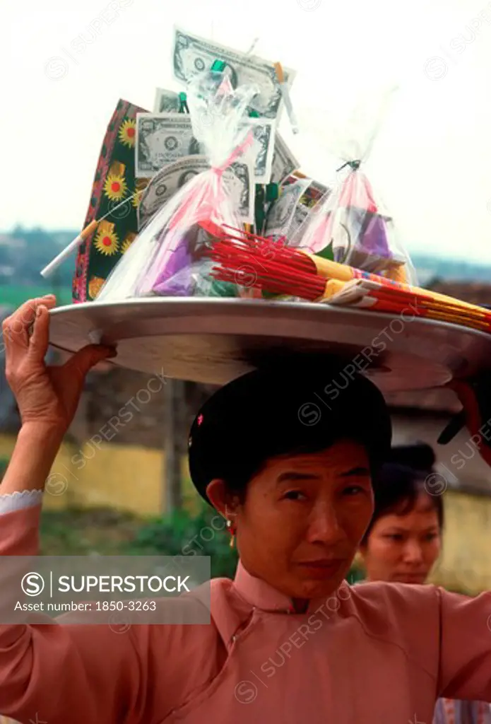 Vietnam, Den Ba Chua Kho , Woman Carrying A Display Of Temple Offerings And Money On Her Head