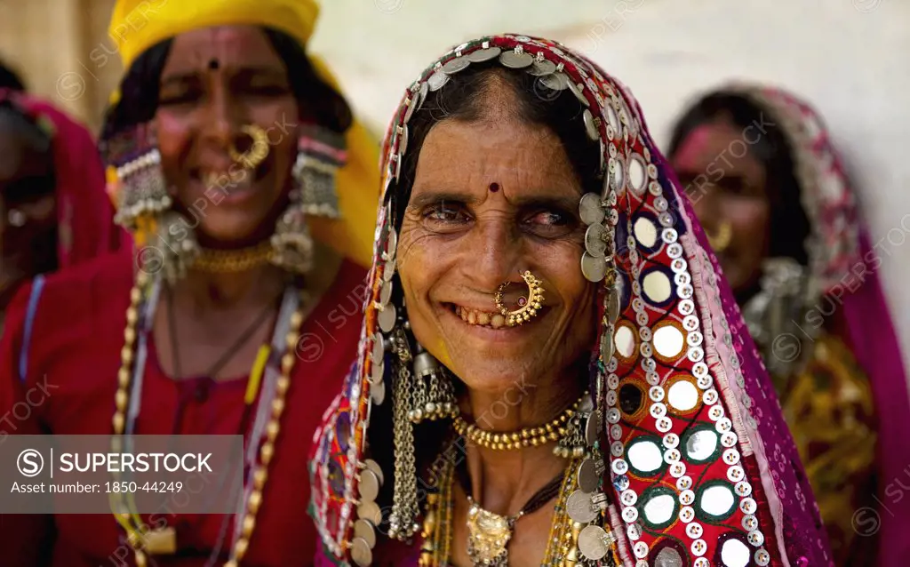 India, Karnataka, People, Smiling Lambani Gypsy women wearing gold nose rings.Tribal forest dwellers now settled in 30-home rural hamlets. Related to the Rabaris gypsies of Kutch Gujarat.