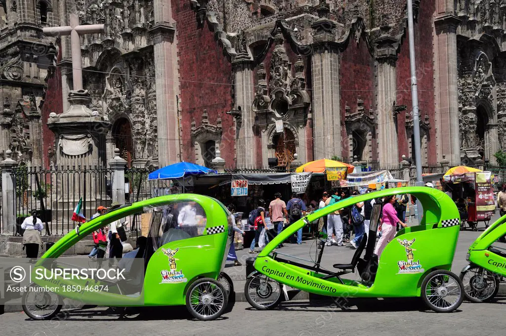 Mexico,  Federal District, Mexico City, Pedi taxis outside the Cathedral in the Zocalo.