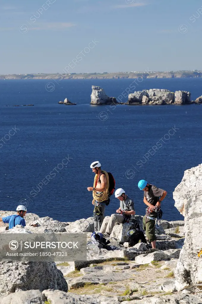 Sport, Rock Climbing, Climbers, France Brittany Gulf of Brest Climbers preparing to scale Pointe de Penhir.