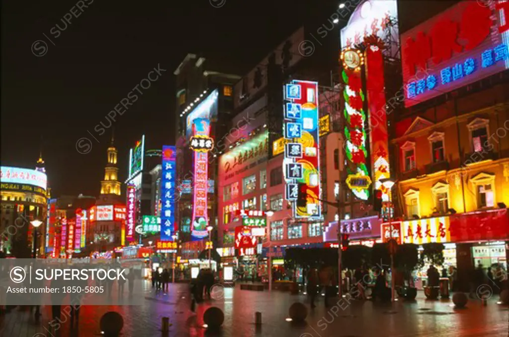 China, Shanghai, Busy Pedestrianised Street With Neon Signs And Advertising Hoardings Illuminated At Night.