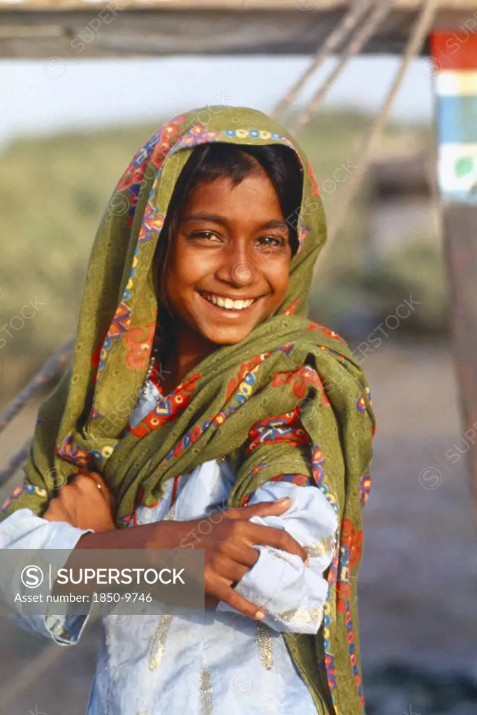 Pakistan, Sindh Province, Karachi, Smiling Sindhi Gypsy Girl Wearing Head Dress.