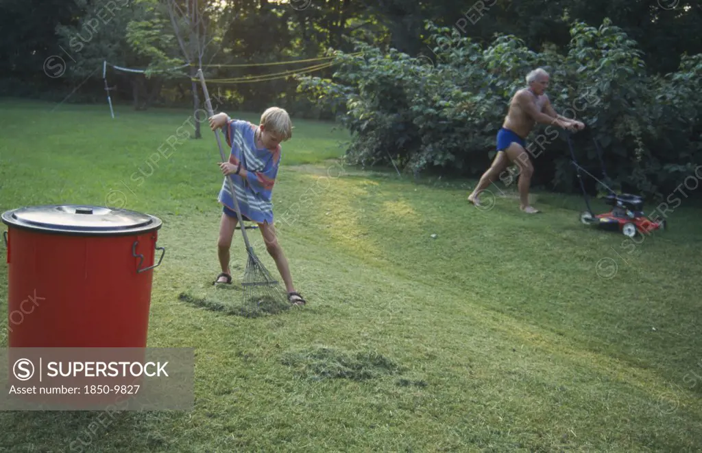 England, Gardens, Father And Eight Year Old Boy Gardening.