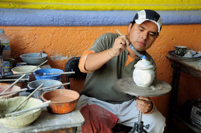 Mexico, Puebla, Talavera ceramic artist at Armando Gallery.