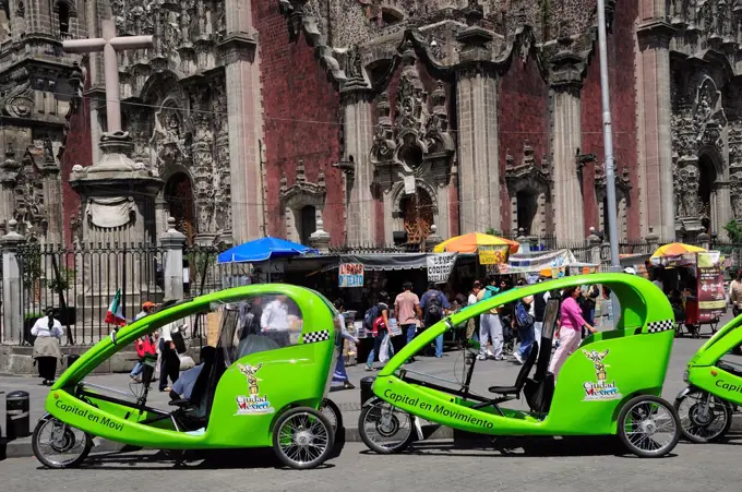 Mexico,  Federal District, Mexico City, Pedi taxis outside the Cathedral in the Zocalo.