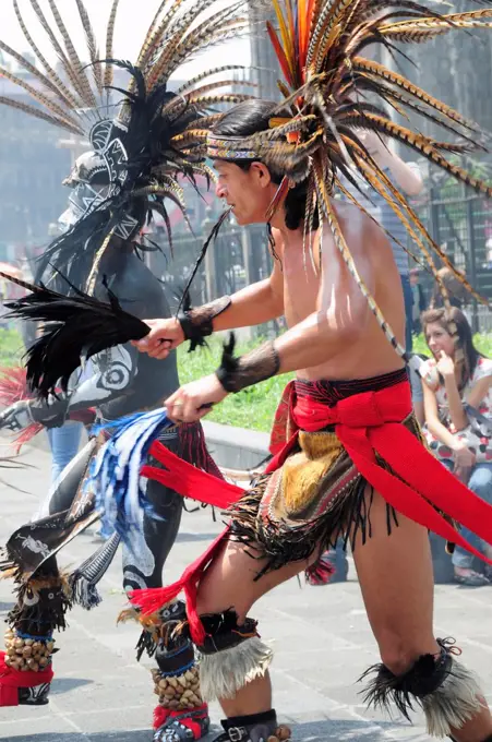 Mexico, Federal District, Mexico City, Michacoa Aztec dancers performing in the Zocalo.