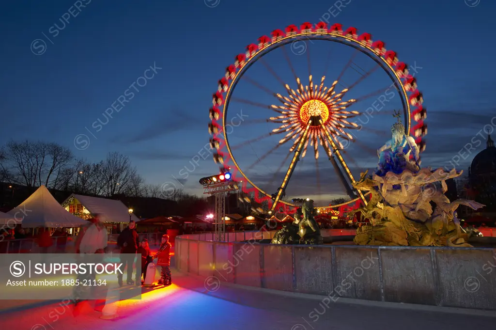 Germany, Brandenburg, Berlin, Christmas Market - funfair and ice rink at night