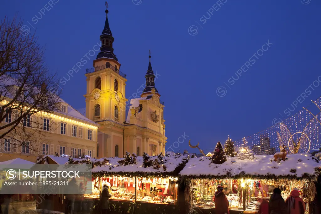 Germany, Baden Wurttemberg, Ludwigsburg, Christmas Market and church at dusk