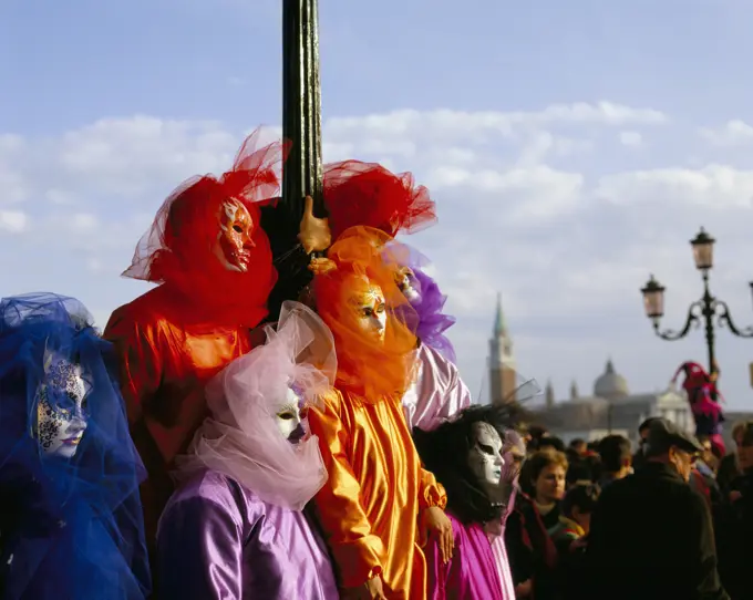 Italy, Veneto, Venice, Venice Carnival - colourful masked figures