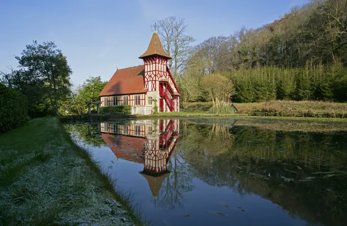 UK - England, Somerset, Rickford, Colouful church beside river in winter