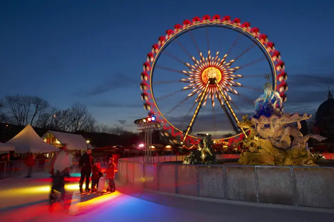 Germany, Brandenburg, Berlin, Christmas Market - funfair and ice rink at night