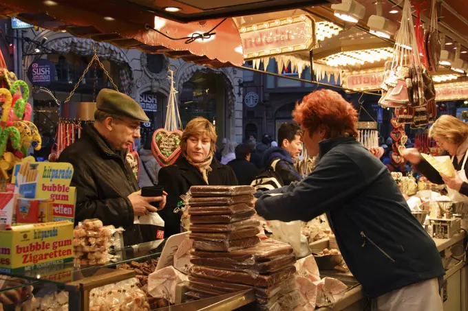 Germany, Hesse, Frankfurt, Altstadt Christmas Market - customers being served at food stall