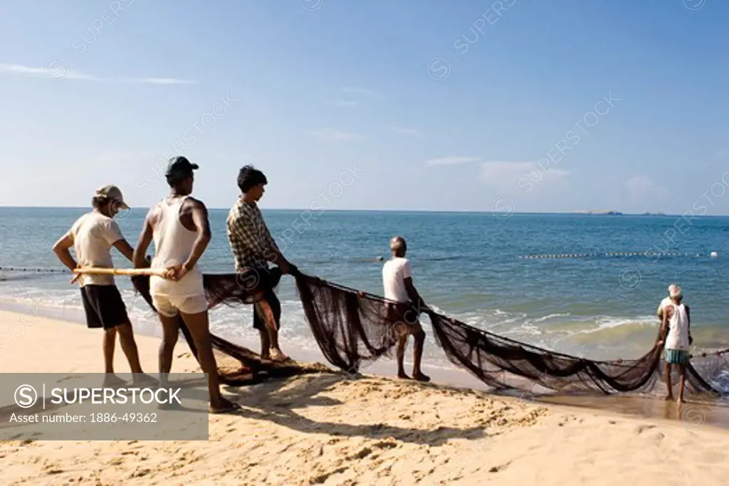 Fishermen pulling big net; Village Bhogwe ; Konkan ; District