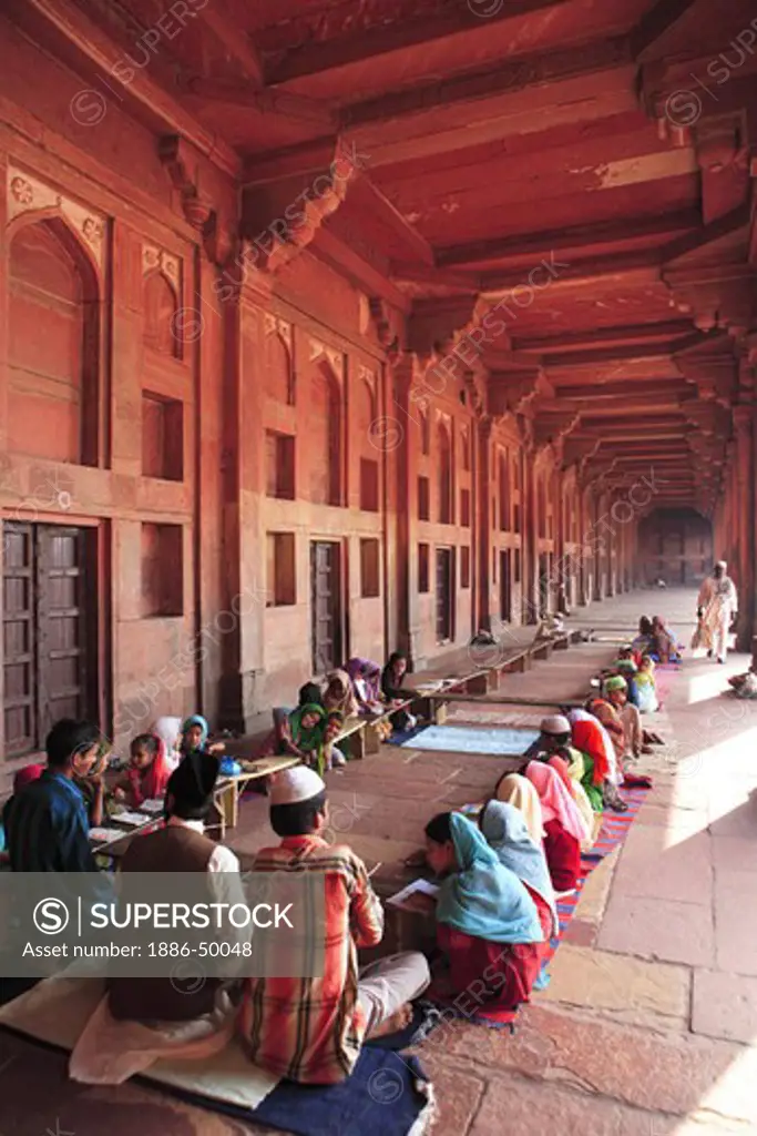 Students studying in Urdu Muslim School classroom Madarasa in Jami Masjid in Fatehpur Sikri built during second half of 16th century ; Agra; Uttar Pradesh ; India UNESCO World Heritage Site