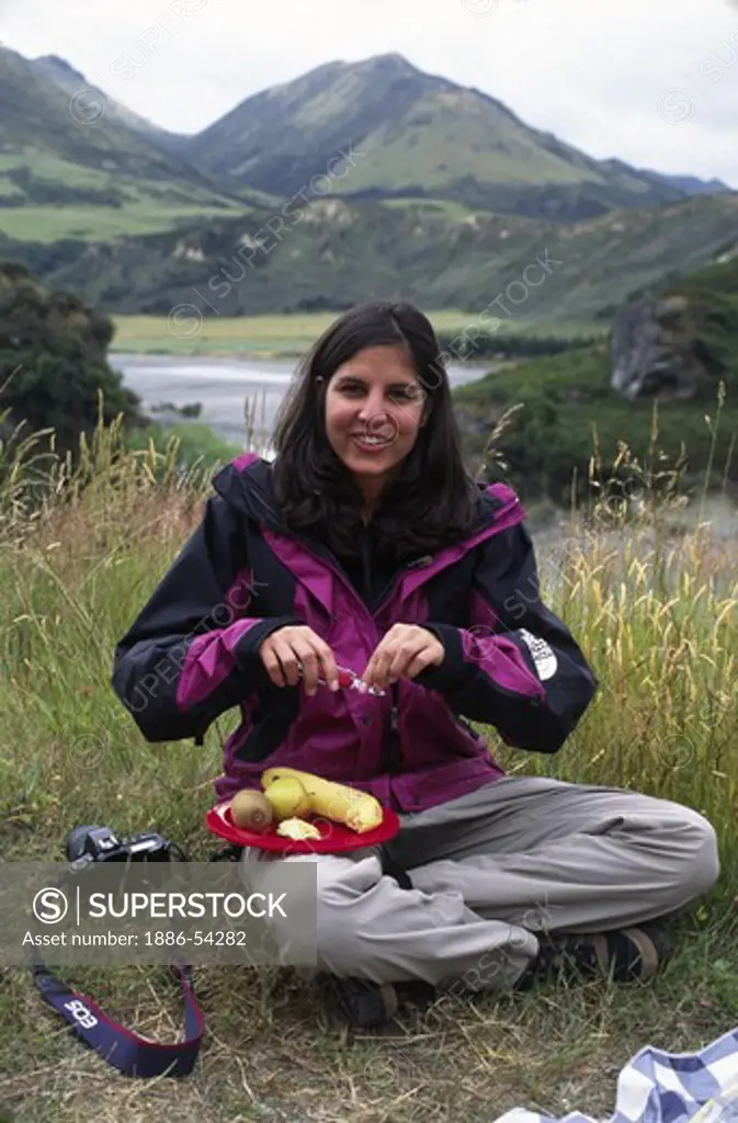 Travelers eat lunch overlooking the WAIAU RIVER VALLEY near HY 7 - SOUTH ISLAND, NEW ZEALAND