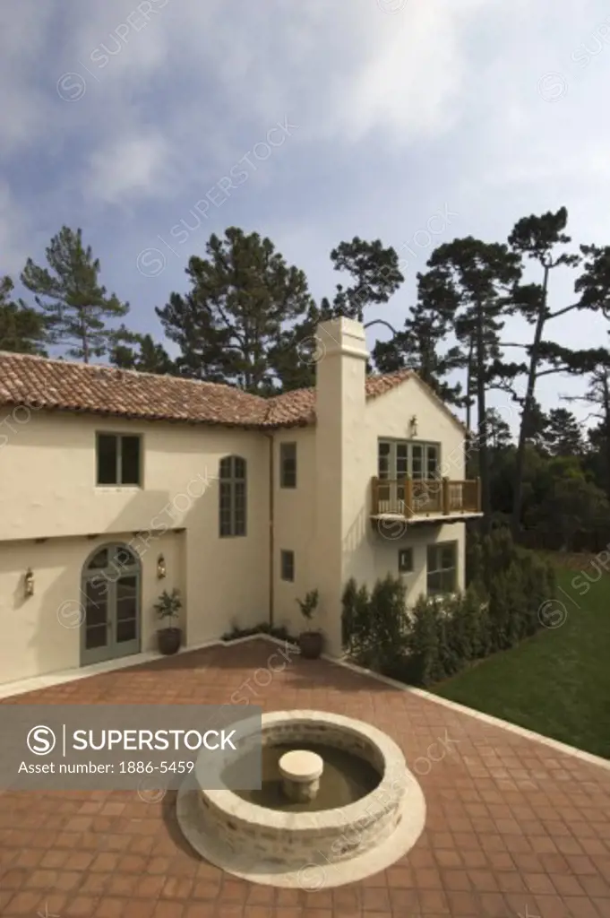 Exterior of a SPANISH STYLE CALIFORNIA LUXURY HOME with large red tiled PATIO