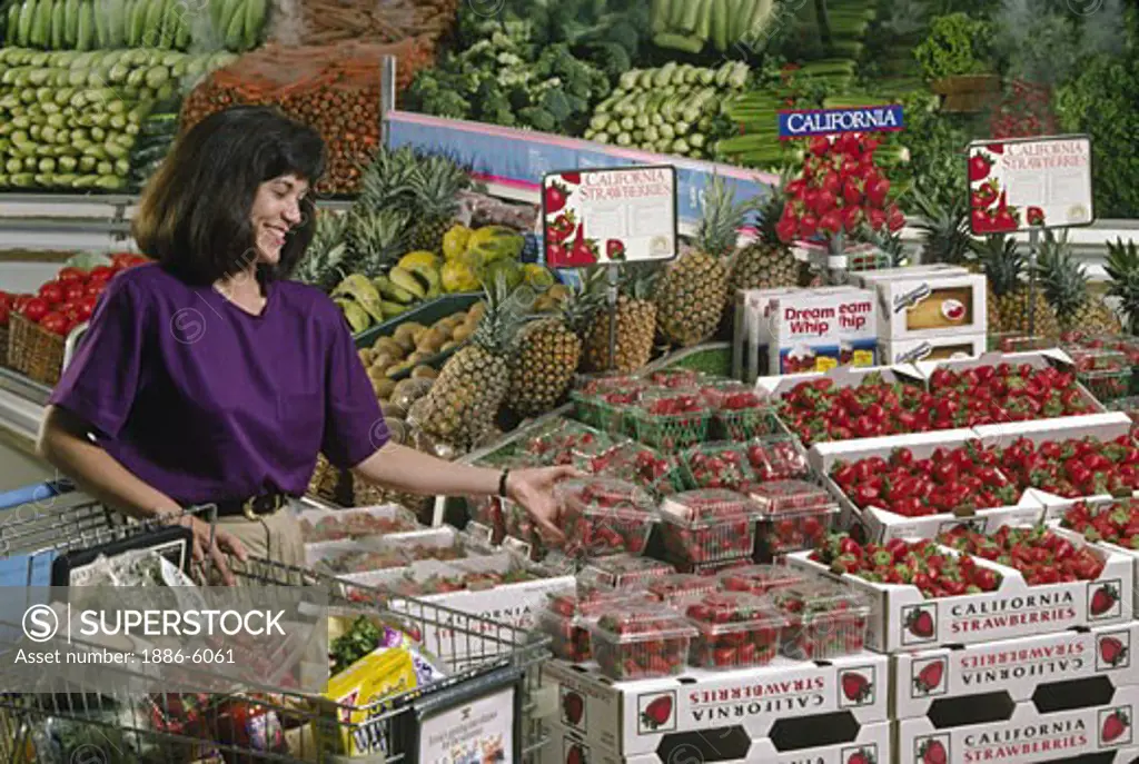 Grocery store STRAWBERRY display with customer  