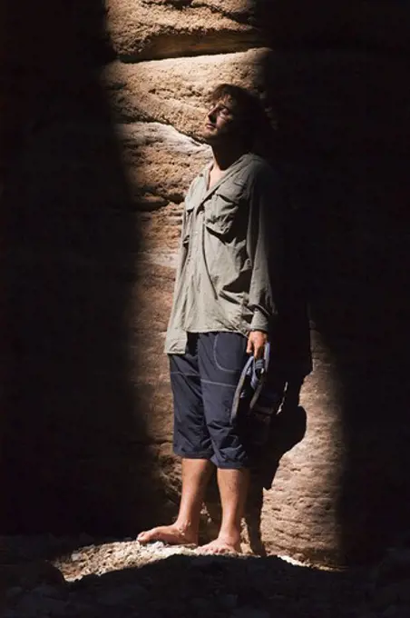 American man  in the slot canyon of BLACK TAIL CANYON NARROWS - GRAND CANYON NATIONAL PARK, ARIZONA