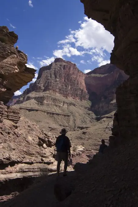 Hiker at the mouth of the Tapeats sandstone slot canyon of DEER CREEK at mile 136  - GRAND CANYON NATIONAL PARK, ARIZONA