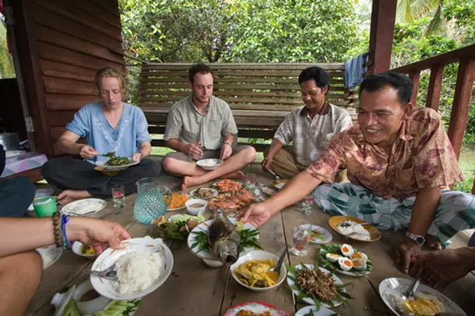 A feast of locally prepared food is shared with home stay eco-tourists in the village of Tung Nang Dam located on the North Andaman Sea - THAILAND