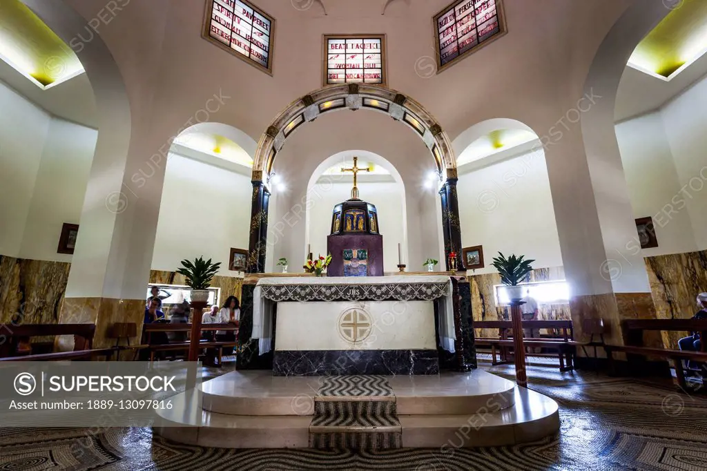 Interior of a church with stained glass windows and altar; Galilee, Israel