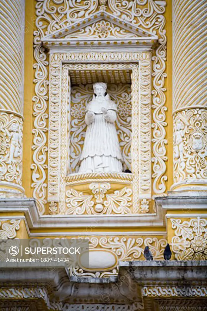 Architectural detail of church's facade, statue of saint; Antigua, Guatemala