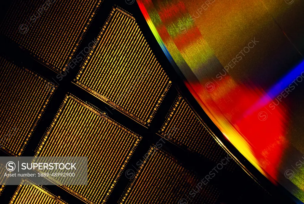 Close-Up Of A Microchip Wafer And A Compact Disk