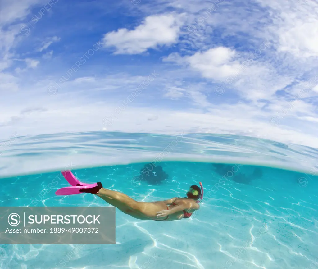 French Polynesia, Moorea, Woman Free Diving In Turquoise Ocean.