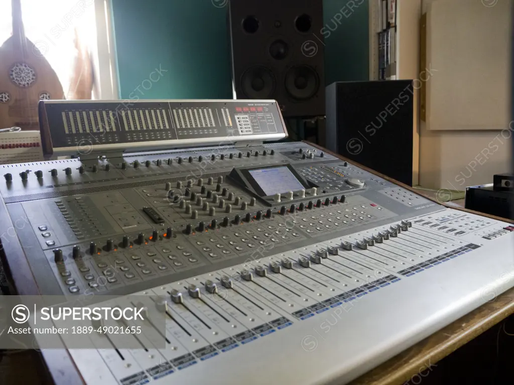 24 channel grey music mixer with loud speakers and a medieval lute near  window, London, UK; London, England - SuperStock