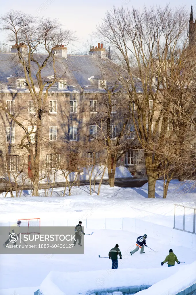 People Playing Hockey On An Outside Skating Rink In Winter, Quebec City