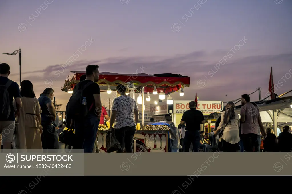 Street vendor in Eminonu Square at night in Fatih, Istanbul; Istanbul, Turkey