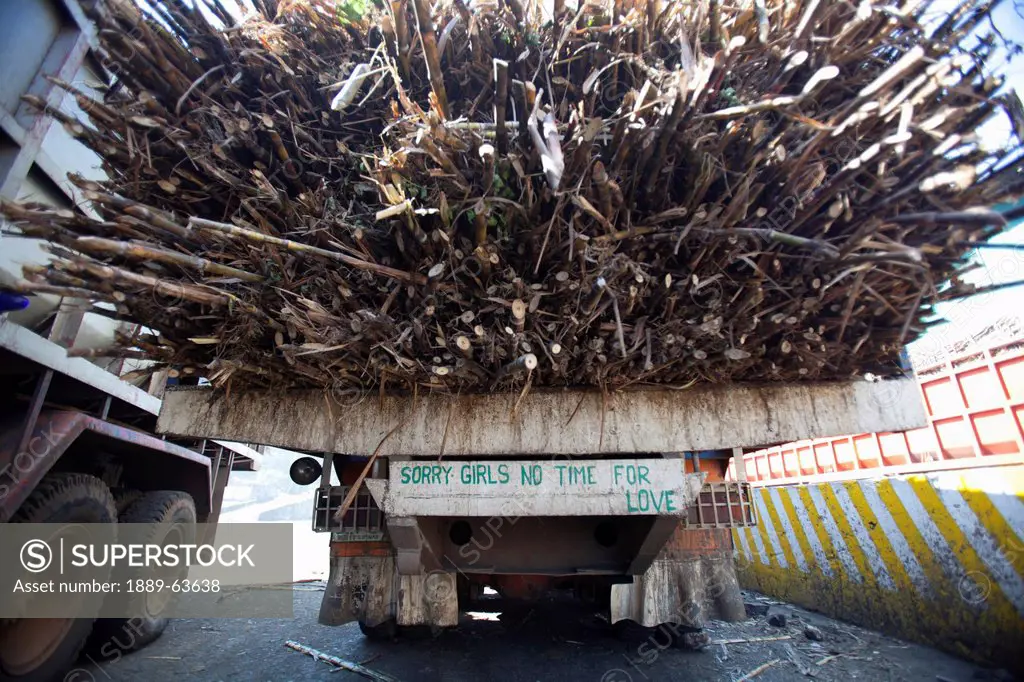 truck loaded with raw sugar cane with the sign ´sorry girls no time for love´, bais city, negros island, philippines