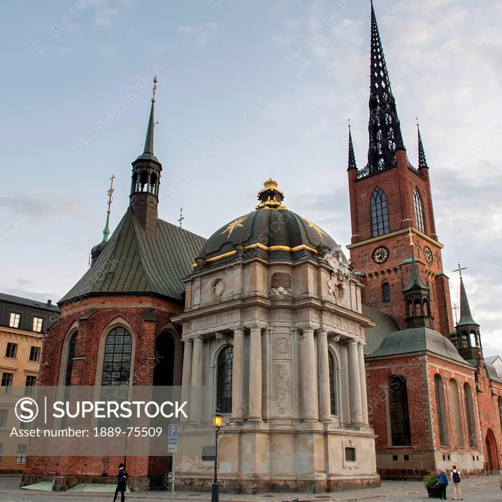 Pedestrians walking on the street by a church building, stockholm sweden