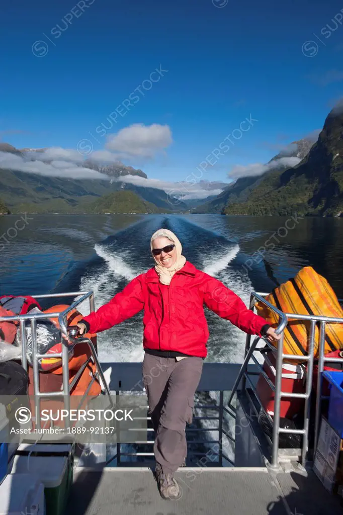 A Traveler Enjoying A Scenic Boat Cruise On Lake Manapouri To Doubtful Sound; New Zealand