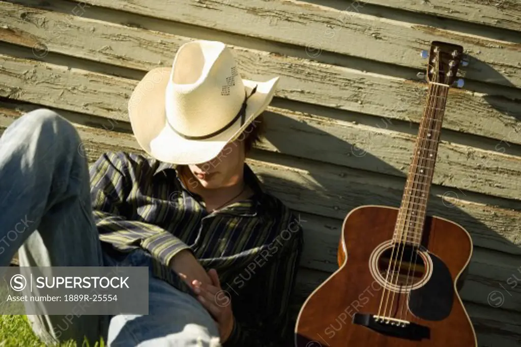 Sleeping cowboy with guitar