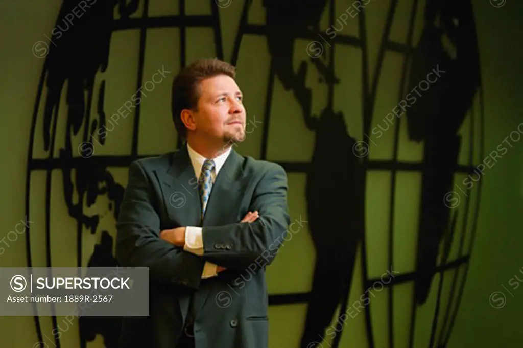 Businessman with image of world in background